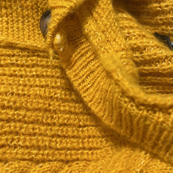 The color of the cardigan is yellow with buttons down the middle. - Picture 6 of 7